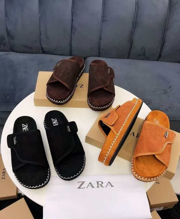 A stylish display of Zara suede slide sandals in black, brown, and tan, showcasing the luxurious texture and sleek design.