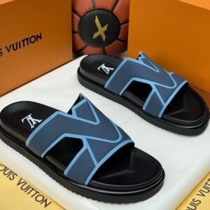 A pair of black and blue slide sandals with a white logo, nestled in a Louis Vuitton box, showcasing luxurious comfort and style.
