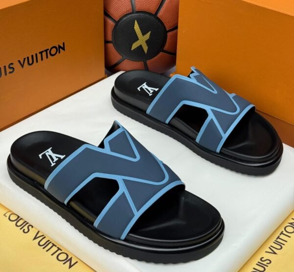 A pair of black and blue slide sandals with a white logo, nestled in a Louis Vuitton box, showcasing luxurious comfort and style.