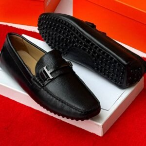 root Luxury gray leather loafers with black studs on the sole, displayed on a white shoe box with an orange background.