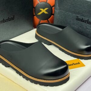 Timberland black clogs with yellow accents on a white box