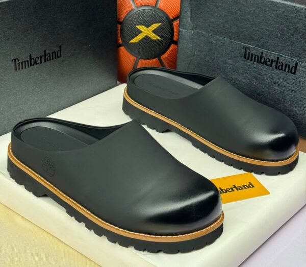 Timberland black clogs with yellow accents on a white box